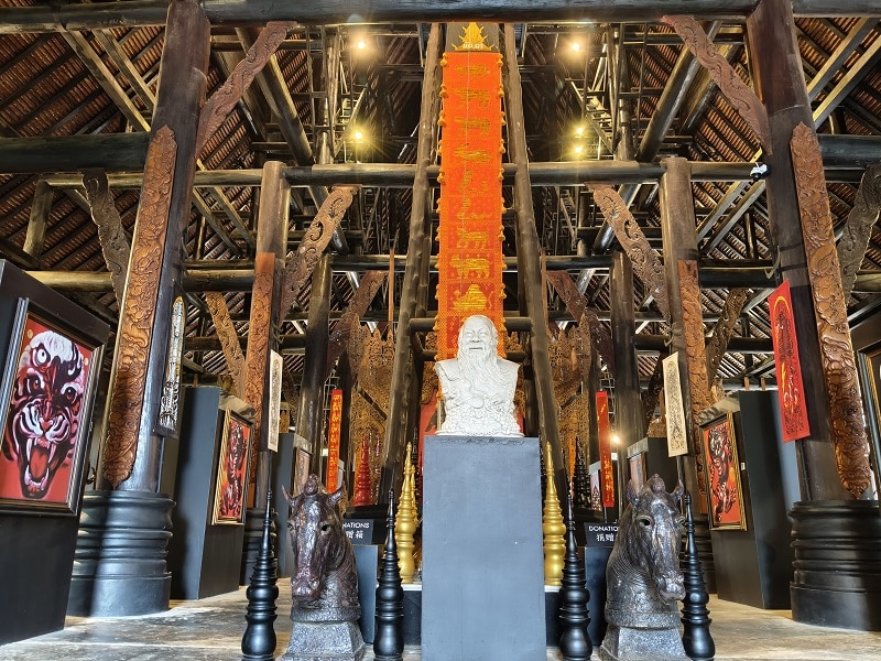 Interior display of artwork and traditional artifacts inside Baan Dam Museum