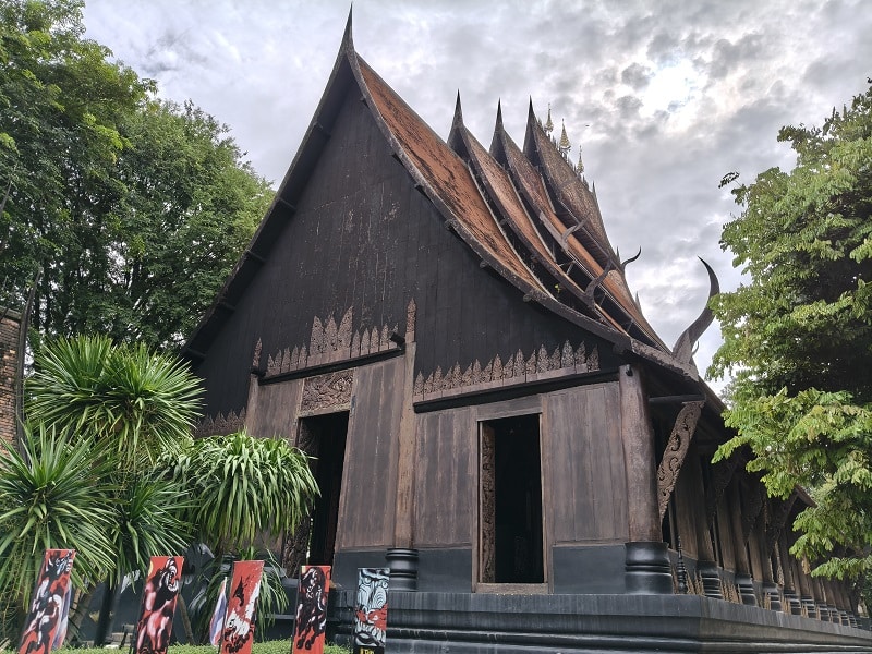 Main Black House building at Baan Dam Museum surrounded by gardens in Chiang Rai