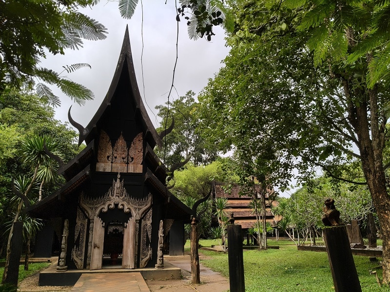 Walking paths through Baan Dam Museum grounds in Chiang Rai Thailand