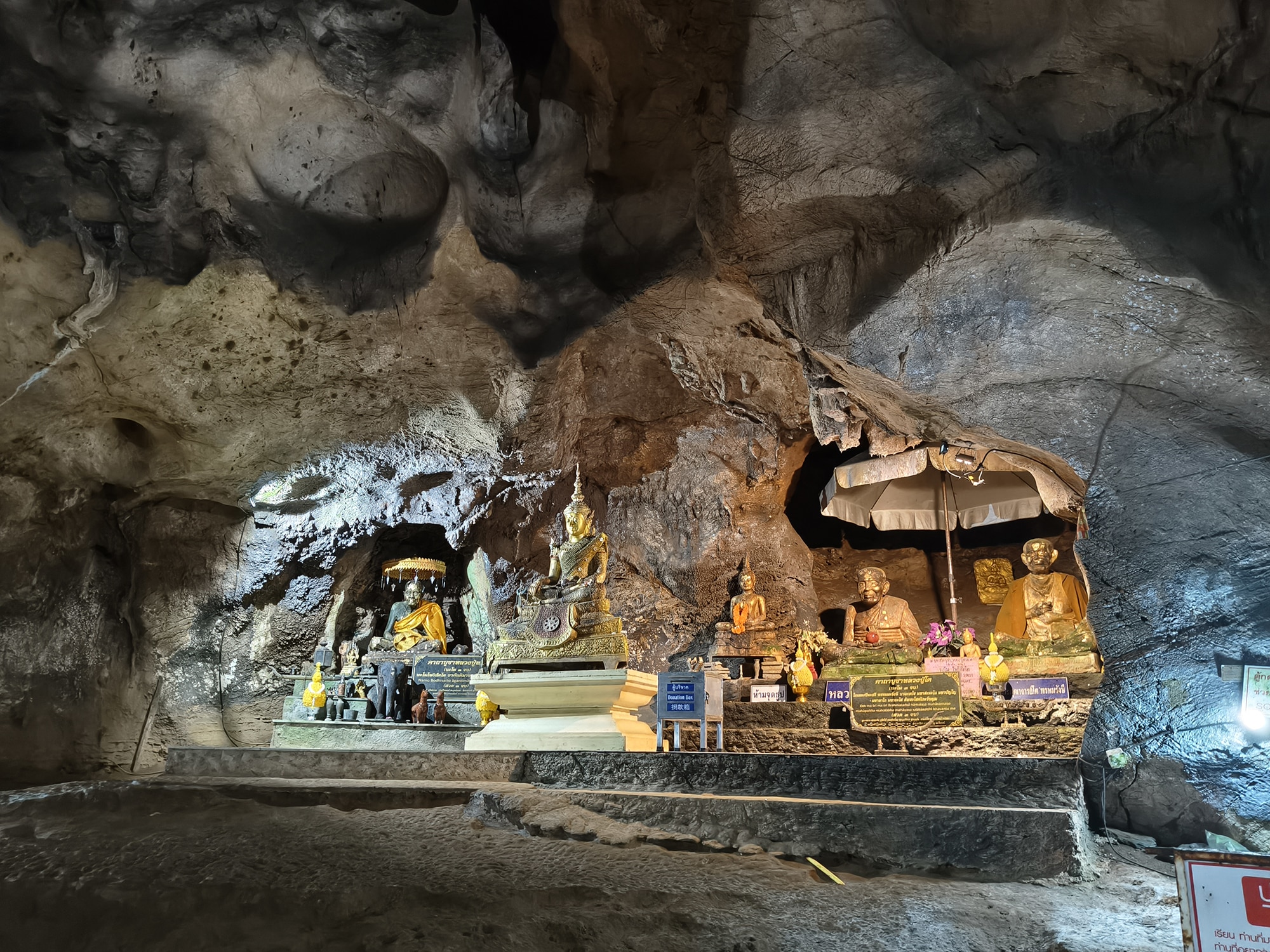 Buddha statues inside Chiang Dao Cave illuminated by soft lights