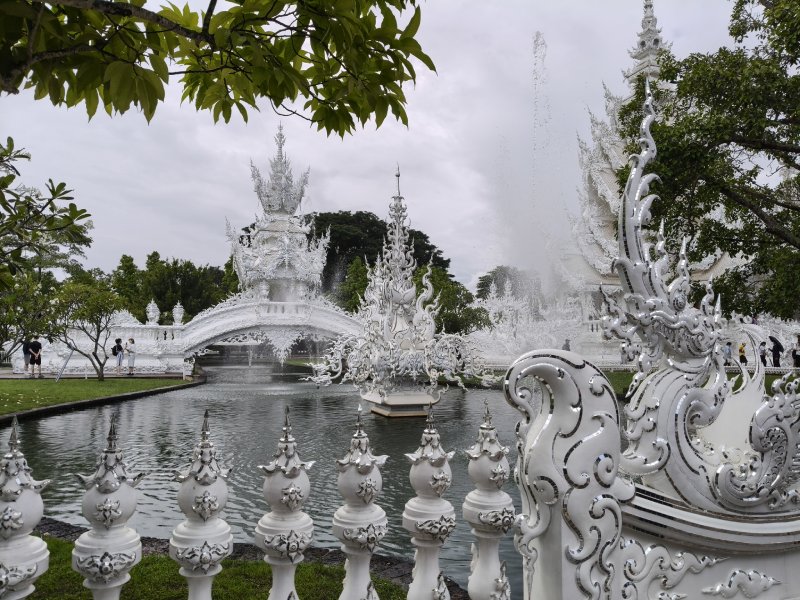 White Temple Bridge of Rebirth Exploring Chiang Rai by rental car? The White Temple is a stop worth making.