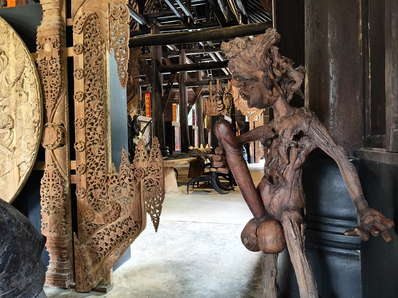 Intricate carved wooden details on a traditional building at Baan Dam Museum